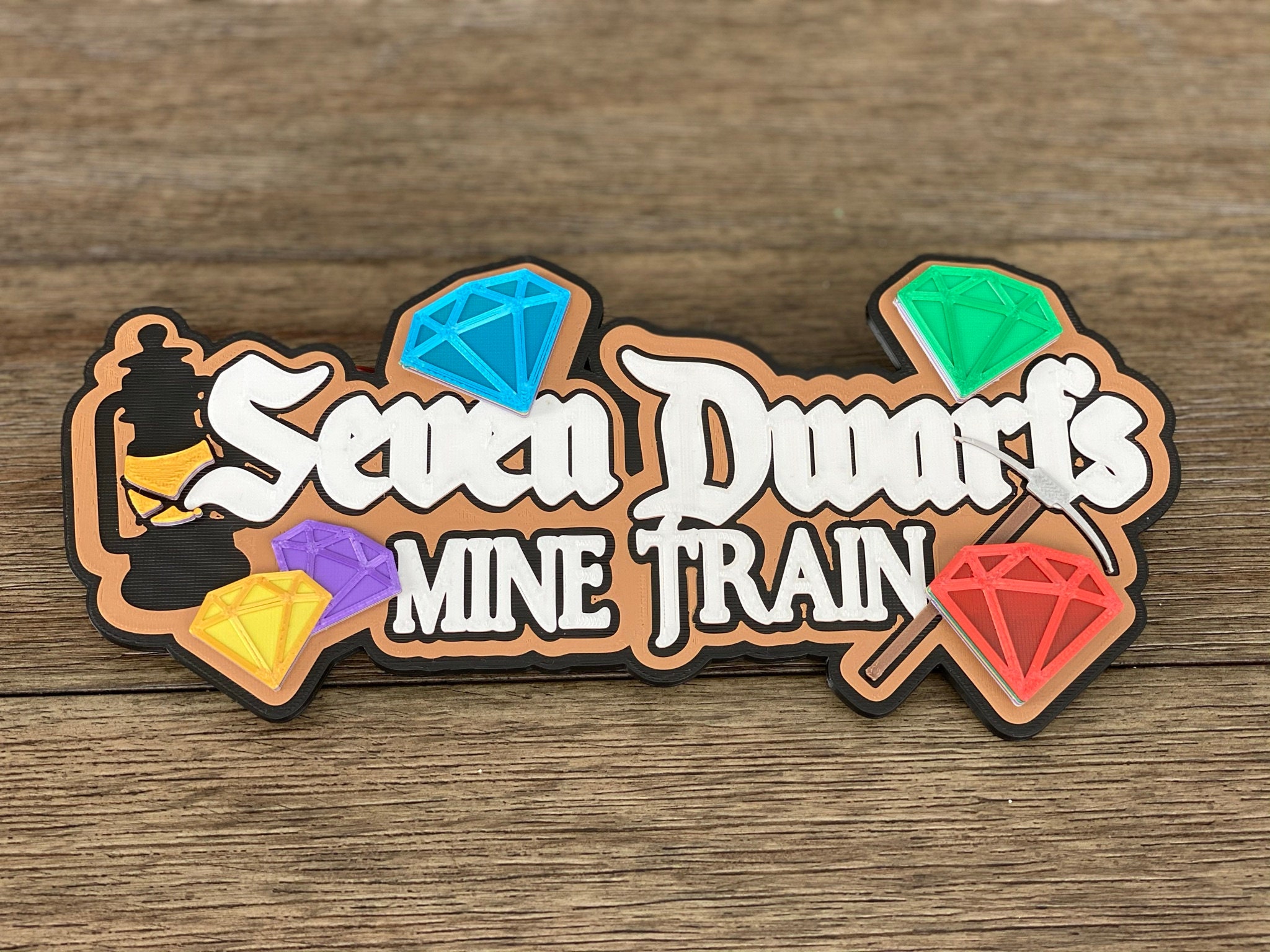 seven dwarfs mine train logo