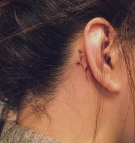 glasses tattoo behind ear meaning