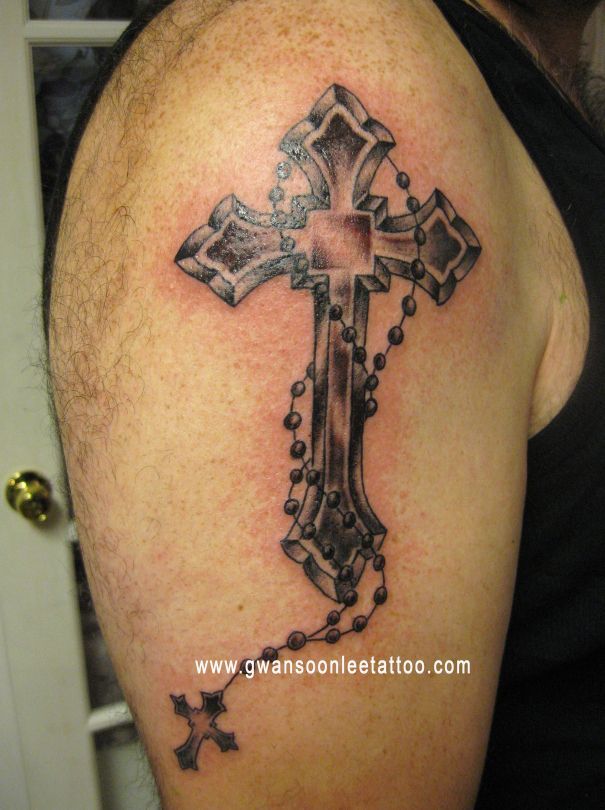 tattoo with rosary beads and cross