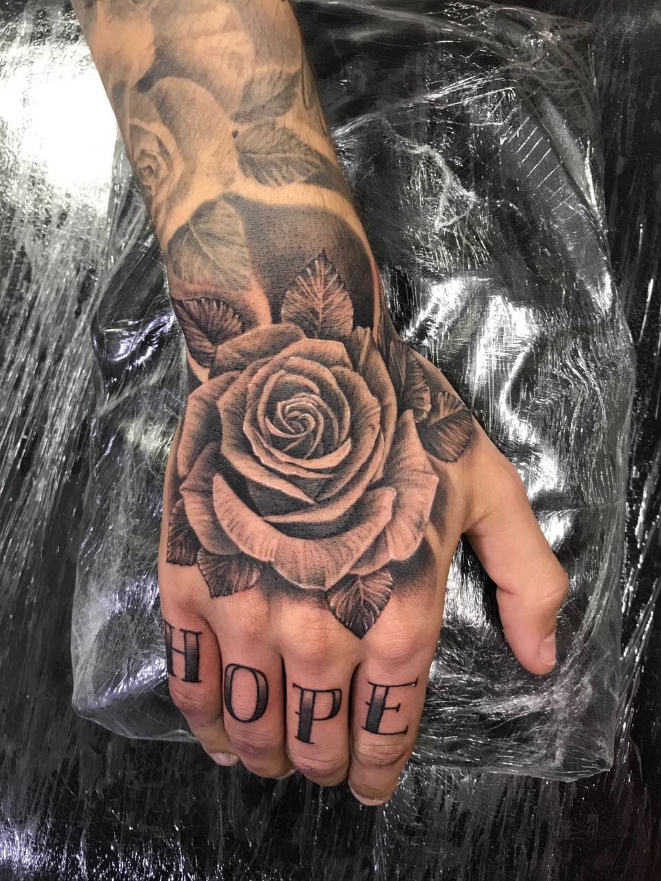 rose tattoo on hand